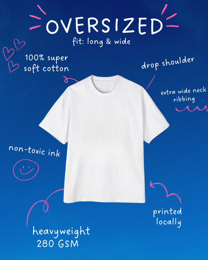 Oversized white T-shirt on blue background with hand-drawn annotations highlighting features like 100% soft cotton, heavyweight 280 GSM, drop shoulder, and non-toxic ink.