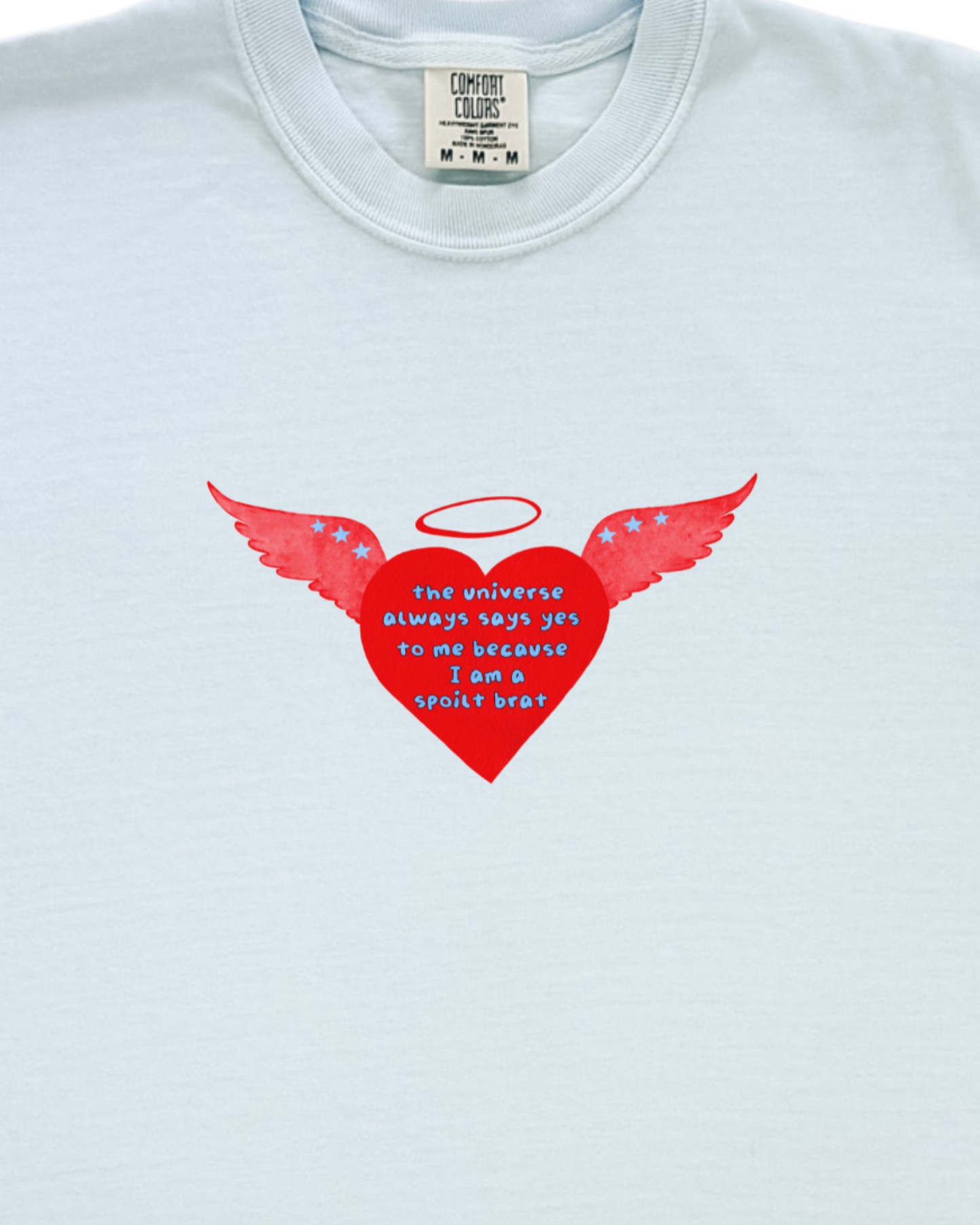 Light blue t-shirt with a red heart design featuring wings and a halo on a white background.