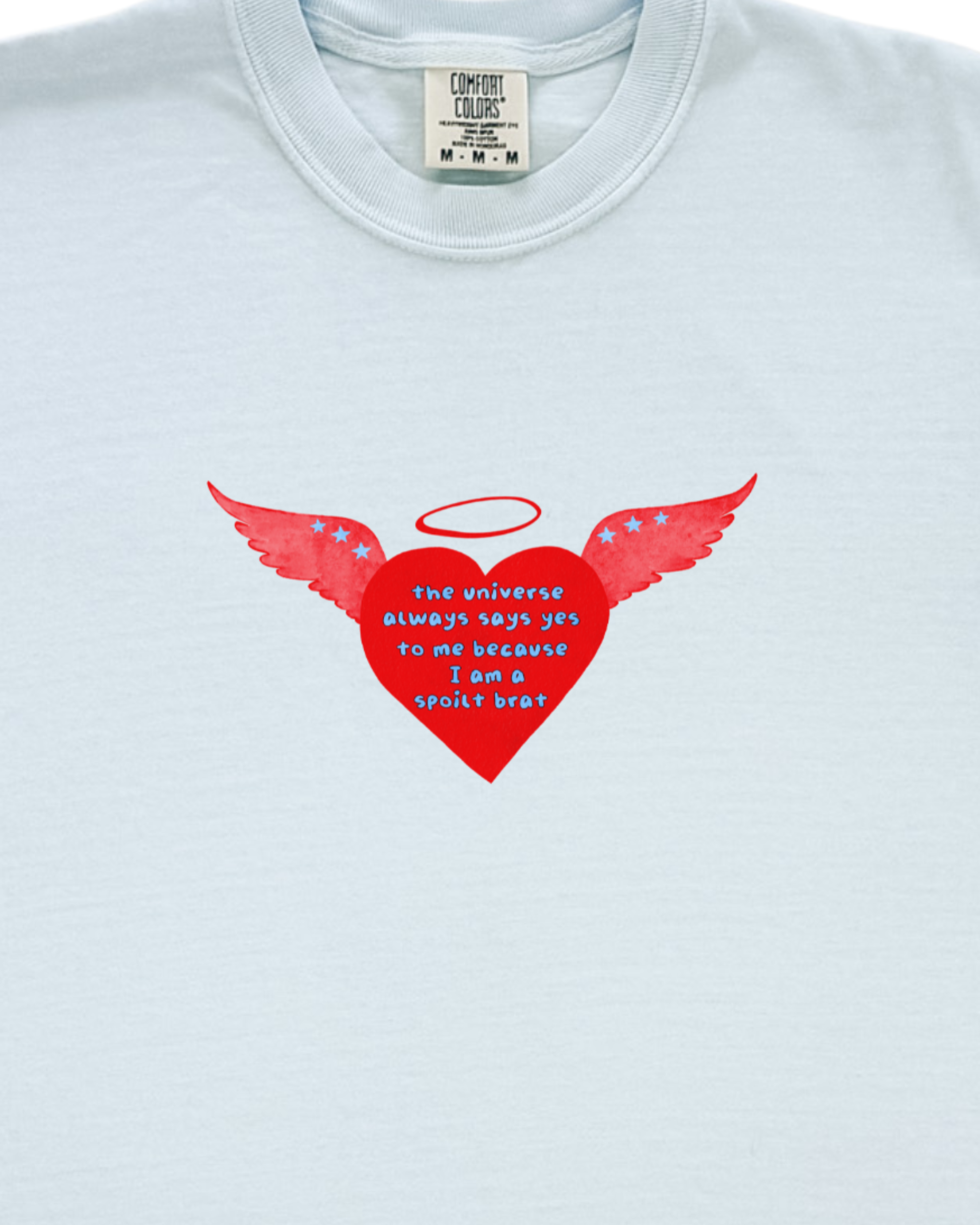 Light blue t-shirt with a red heart design featuring wings and a halo on a white background.