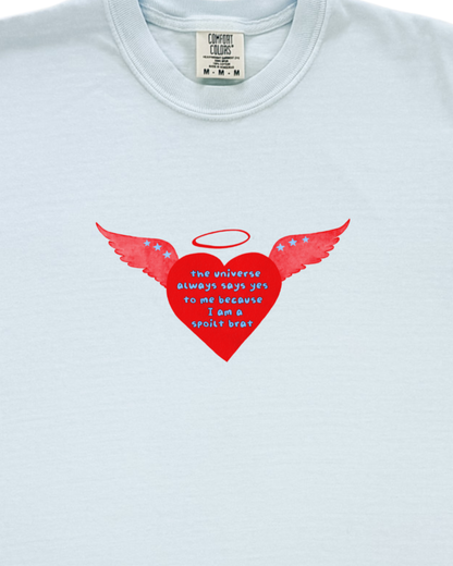 Light blue t-shirt with a red heart design featuring wings and a halo on a white background.