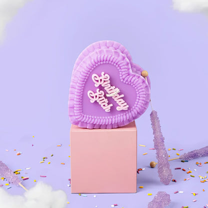 Heart-shaped pink object with 'Birthday bitch' text on a purple background with confetti.