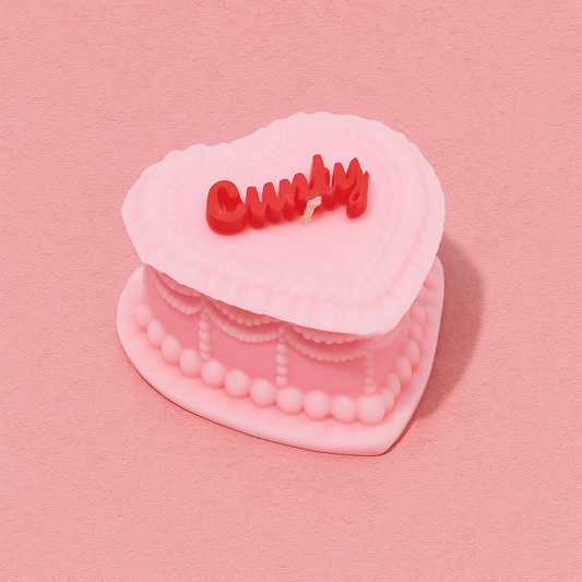 Pink heart candle with red text reading "cunty" on a pink background