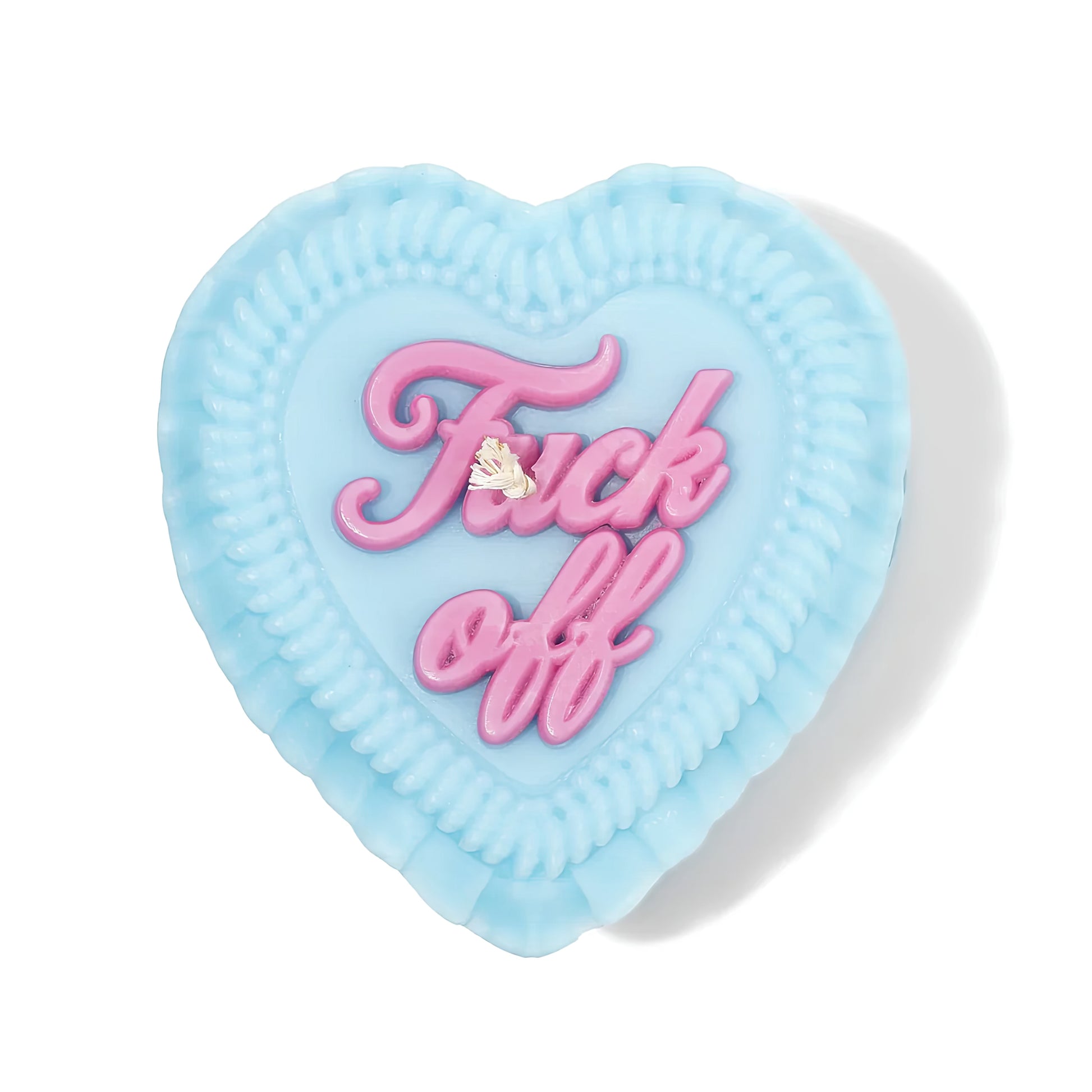Heart-shaped blue gift candle with pink "fuck off" text on a white background